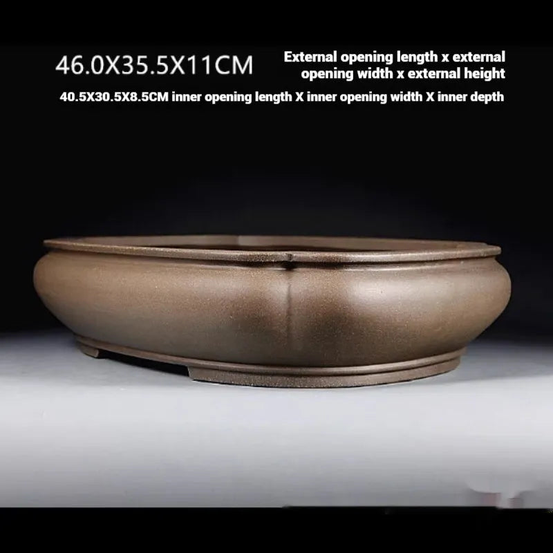 Handmade antique papaya-shaped purple clay flower pot shown from the side.
