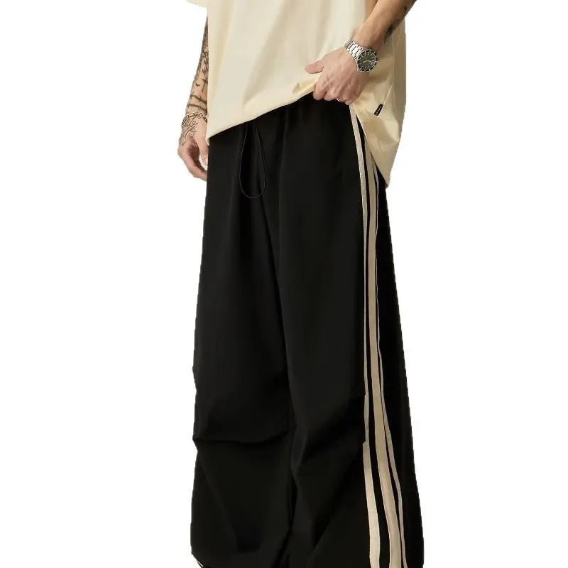 Black men's high-waist wide-leg climbing trousers laid flat, showing straight-leg design.