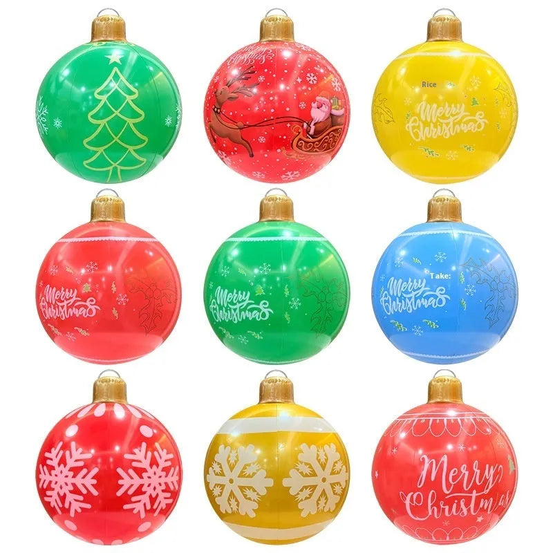 Large red inflatable Christmas ball with flashing LED lights standing in a garden.