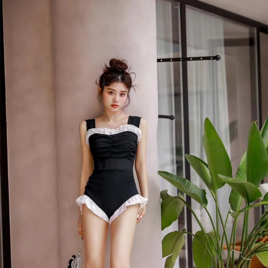 High-waisted one-piece swimsuit in quick-dry polyester fabric, shown in black.