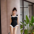 High-waisted one-piece swimsuit in quick-dry polyester fabric, shown in black.