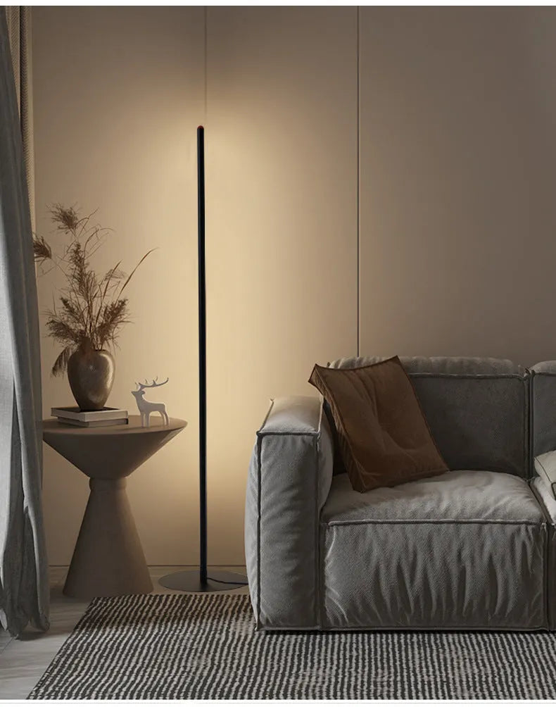 Vertical aluminium alloy floor lamp in modern simple style placed beside a sofa.