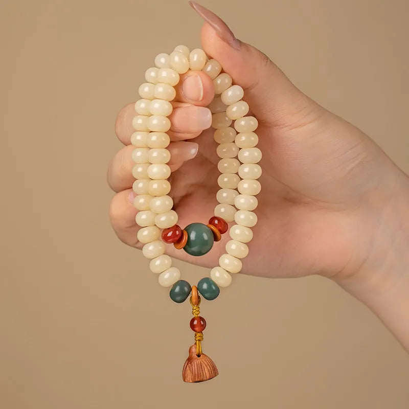 Women's cream topaz Bodhi wooden bracelet with flat round beads on a 15-20cm wrist.