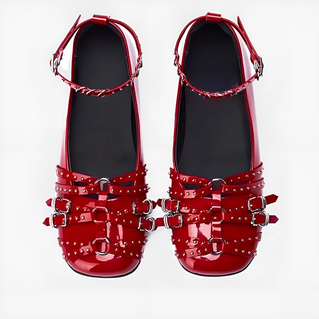 Black women's patent leather buckle pumps with a square toe and flat rubber sole.