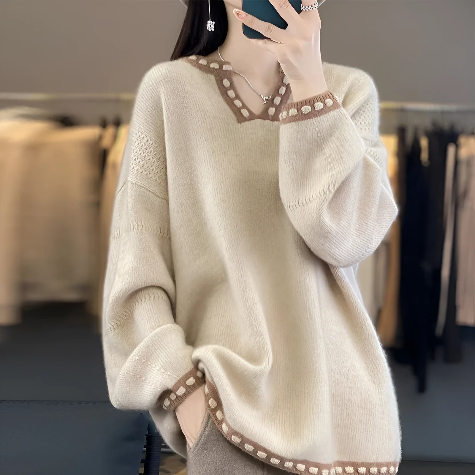 Women's camel coloured V-neck long sleeve viscose knit sweater on a hanger.