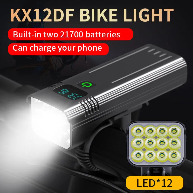 Black KX12DF digital display bicycle headlight with aluminium body mounted on bike handlebars via quick-release bracket.
