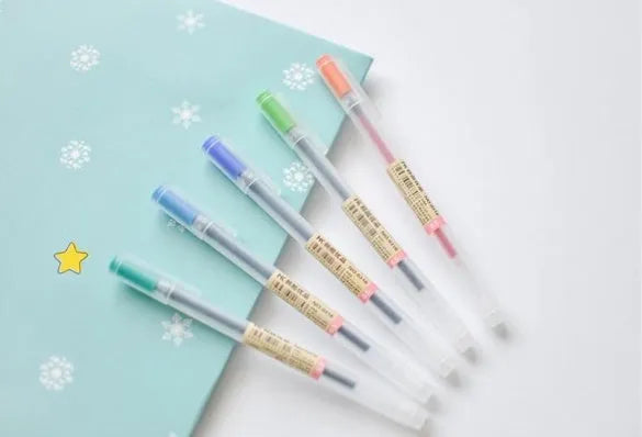 Box of twelve black Muji gel pens with 0.5mm nibs, showcasing leak-prevention design.