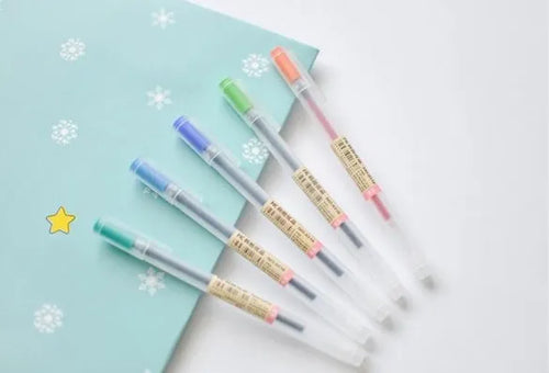 Box of twelve black Muji gel pens with 0.5mm nibs, showcasing leak-prevention design.