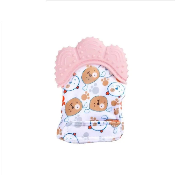 BPA-free silicone baby teether glove fastened with a white Velcro strap on a baby's hand