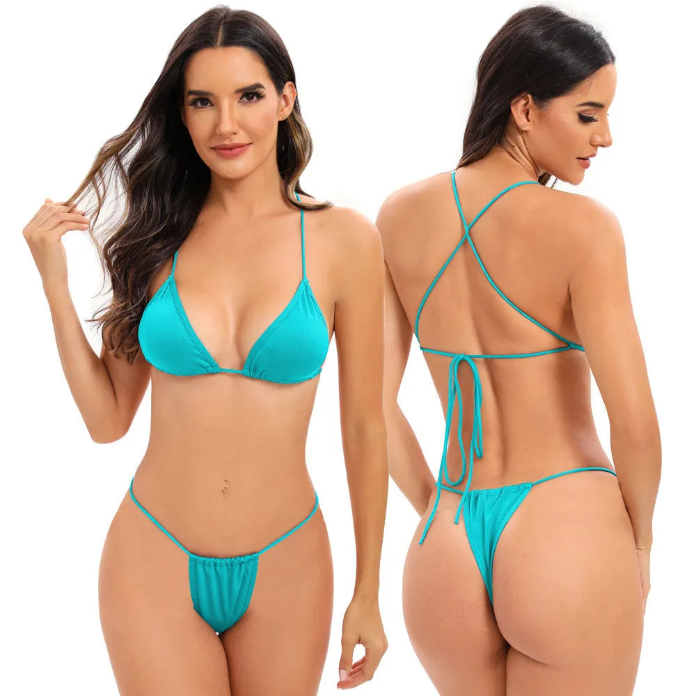 Women's candy coloured cross strap split swimsuit with multiple adjustable straps on a mannequin.