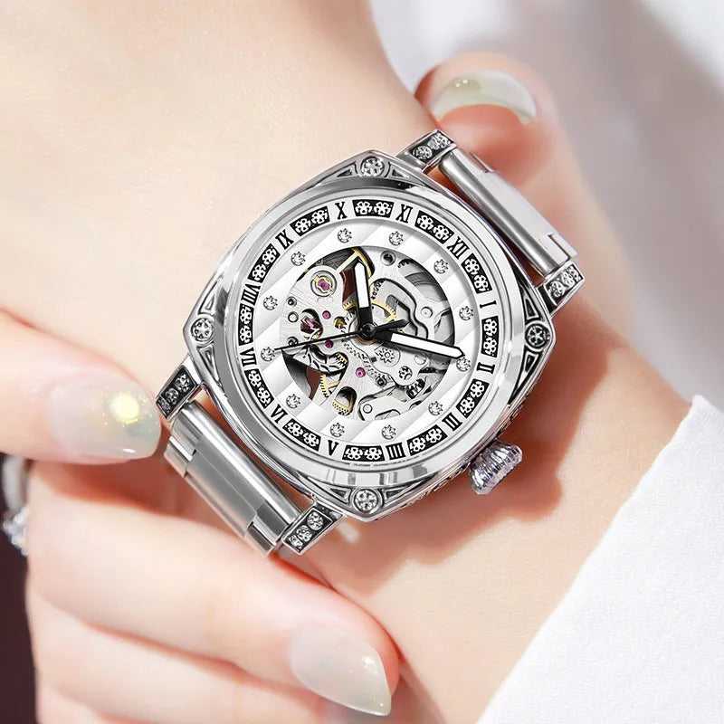 Mechanical watch with luminous hands and a leather strap on a wrist, showing black case variant.