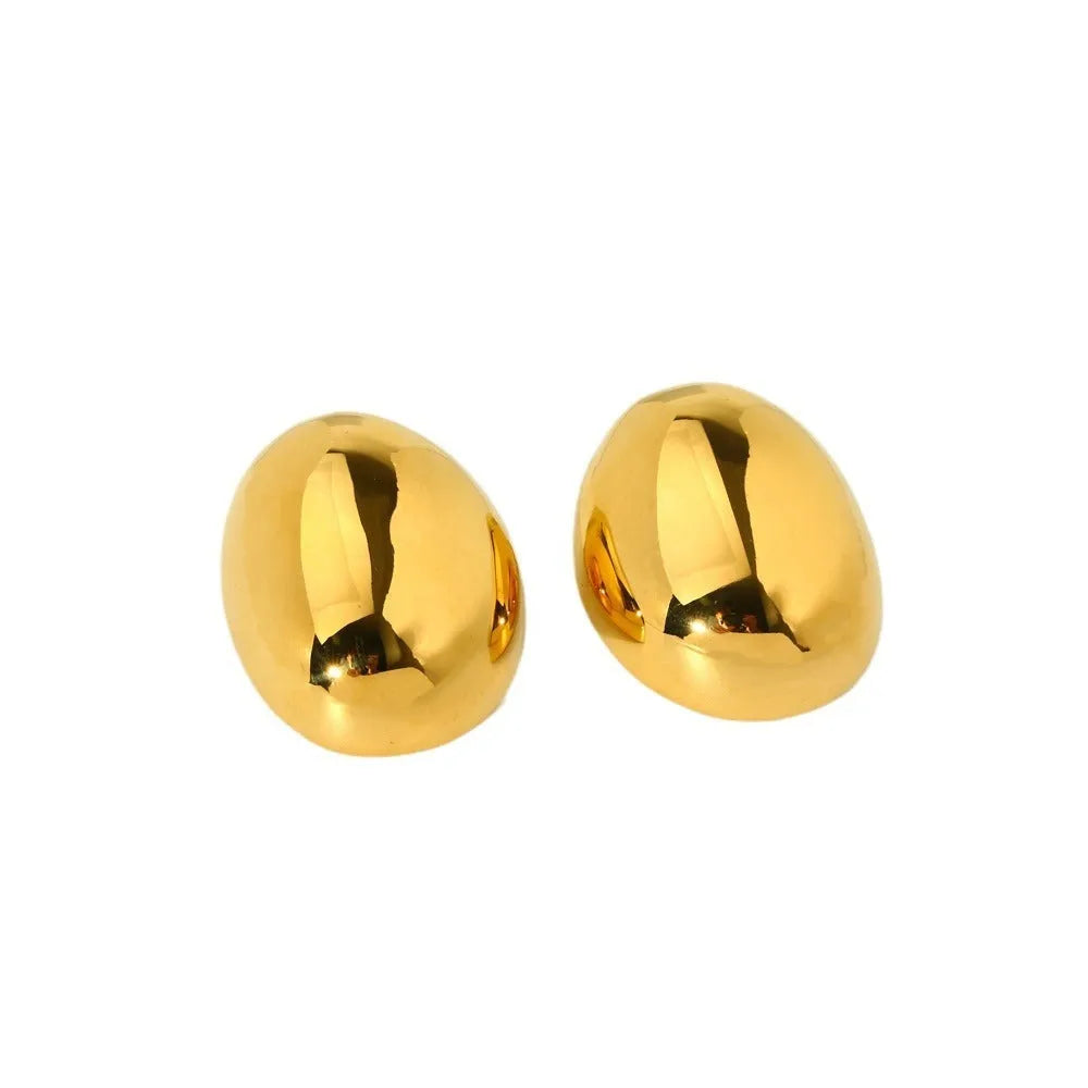 Geometric gold-coloured ear studs with glazed surface and line design details