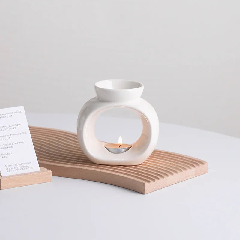 White retro Nordic ceramic aromatherapy stove ornament on a surface.