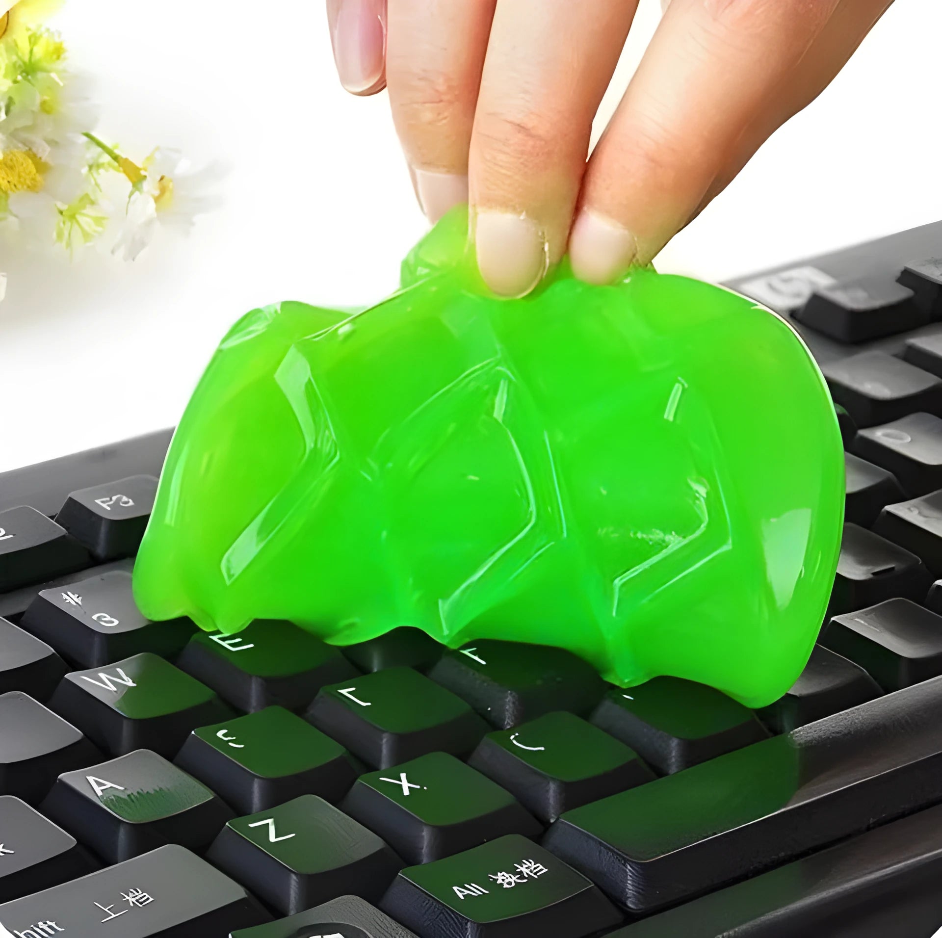 Blue and yellow lumps of Magic Cleaning Gel adhesive putty for dust removal, shown with a car vent and keyboard.