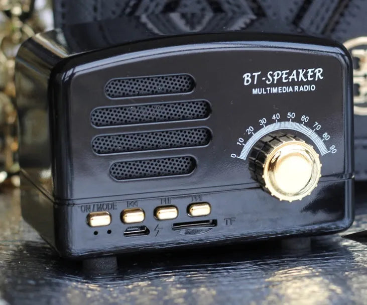 Vintage-style wooden Bluetooth speaker in wood grain finish showing front grille and compact size.