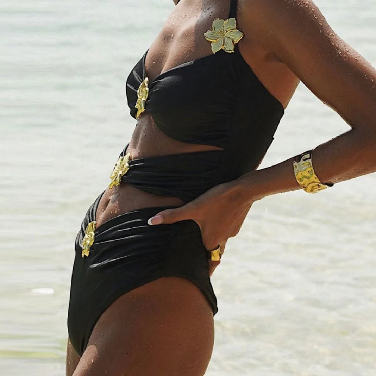 A women's solid colour one-piece swimsuit with a detachable skirt and hollow-out tube top.