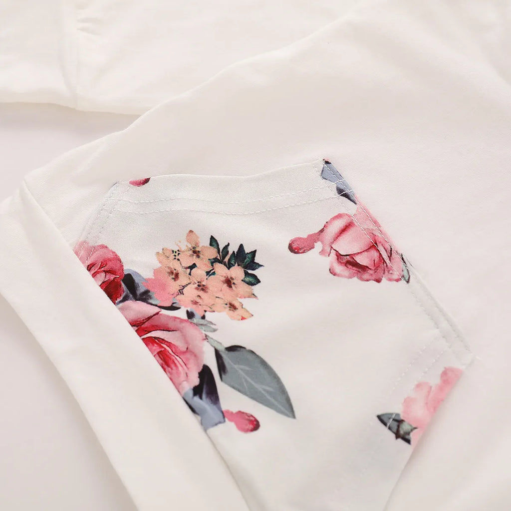 White cotton hooded romper suit for a baby girl with long sleeves and trouser legs.