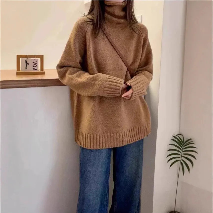 Women's loose fit turtleneck sweater with a thick, textured curling pile collar in a solid colour.