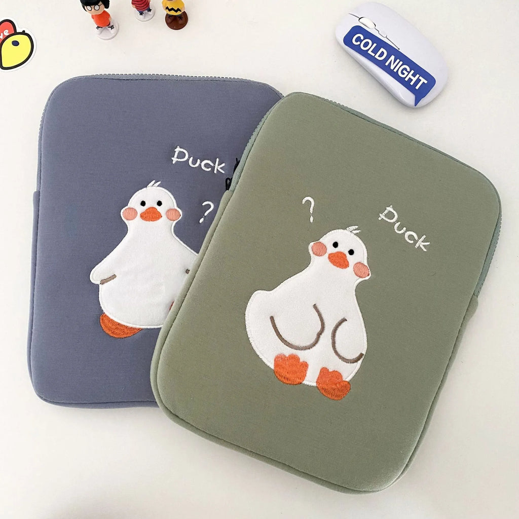 Blue cotton tablet case with embroidered cartoon duck design, showing zipper closure and protective frame.