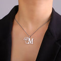 Gold electroplated stainless steel necklace with a cross chain and a letter 'A' pendant on a white background.