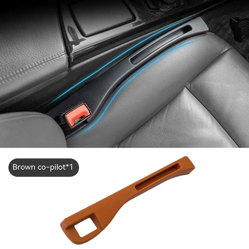 Black plastic car seat gap storage box with handle between vehicle seats