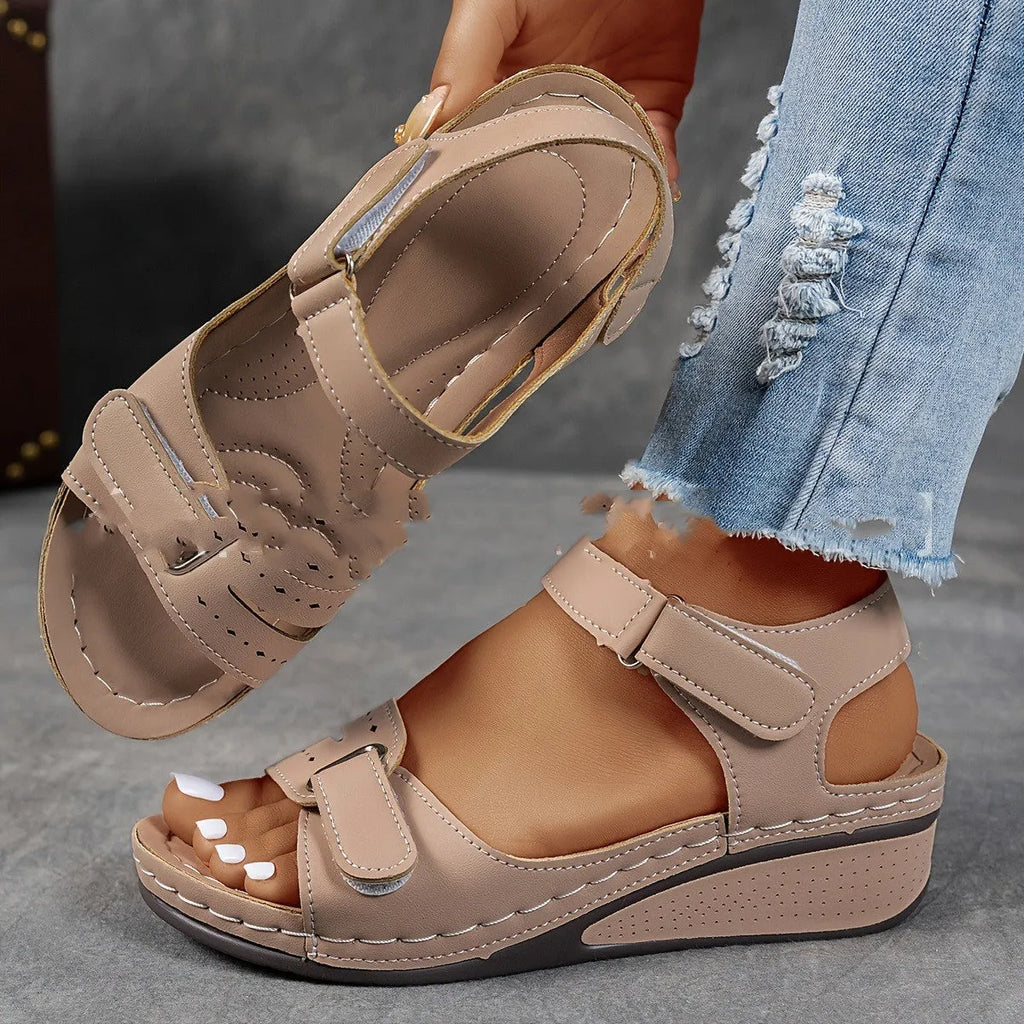 Women's beige thick-bottom strap sandals showing the Velcro fastener and round toe design.