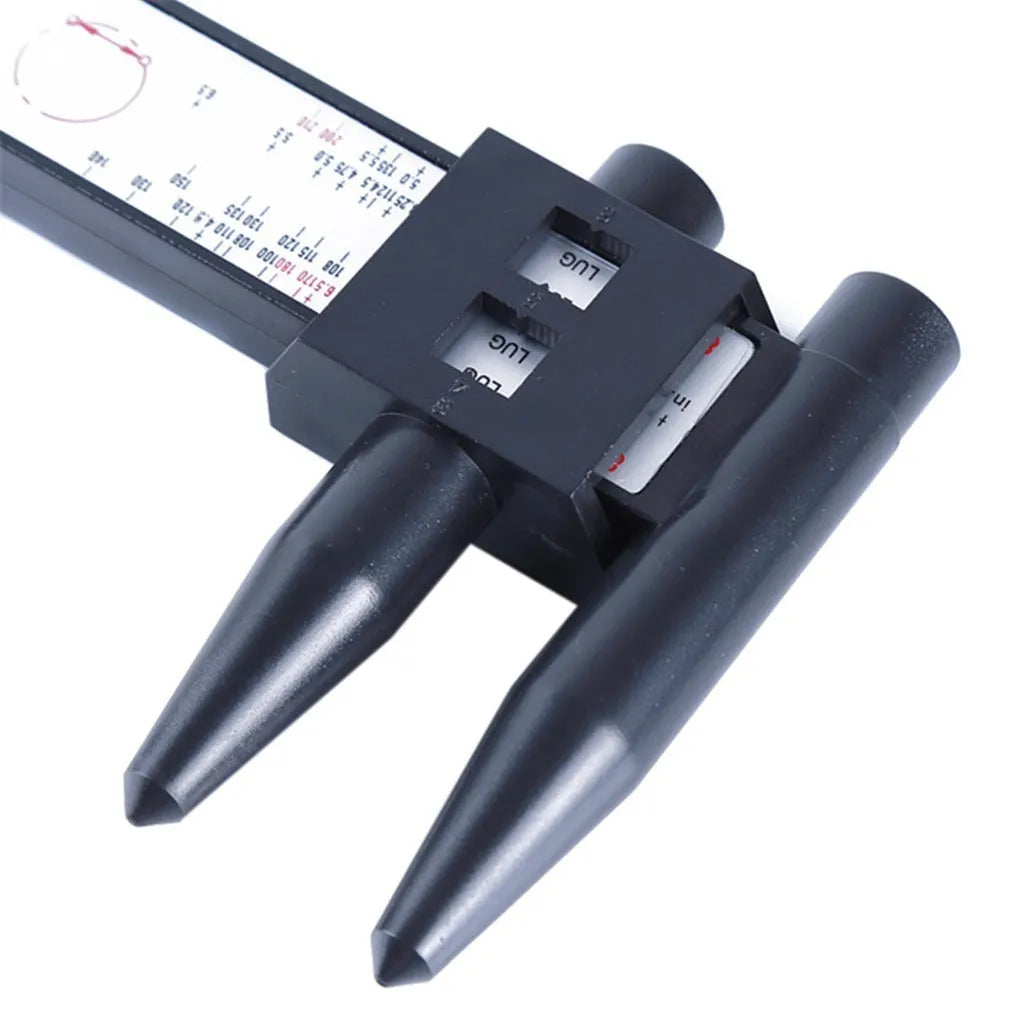 Digital electronic plastic caliper hole distance ruler on a workbench.