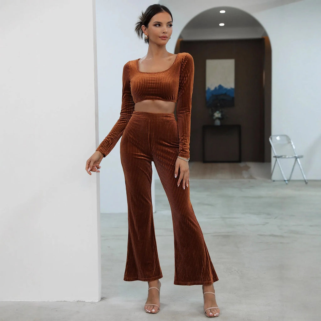 Caramel coloured women's long sleeve sweater and matching straight-leg trousers set on a hanger.