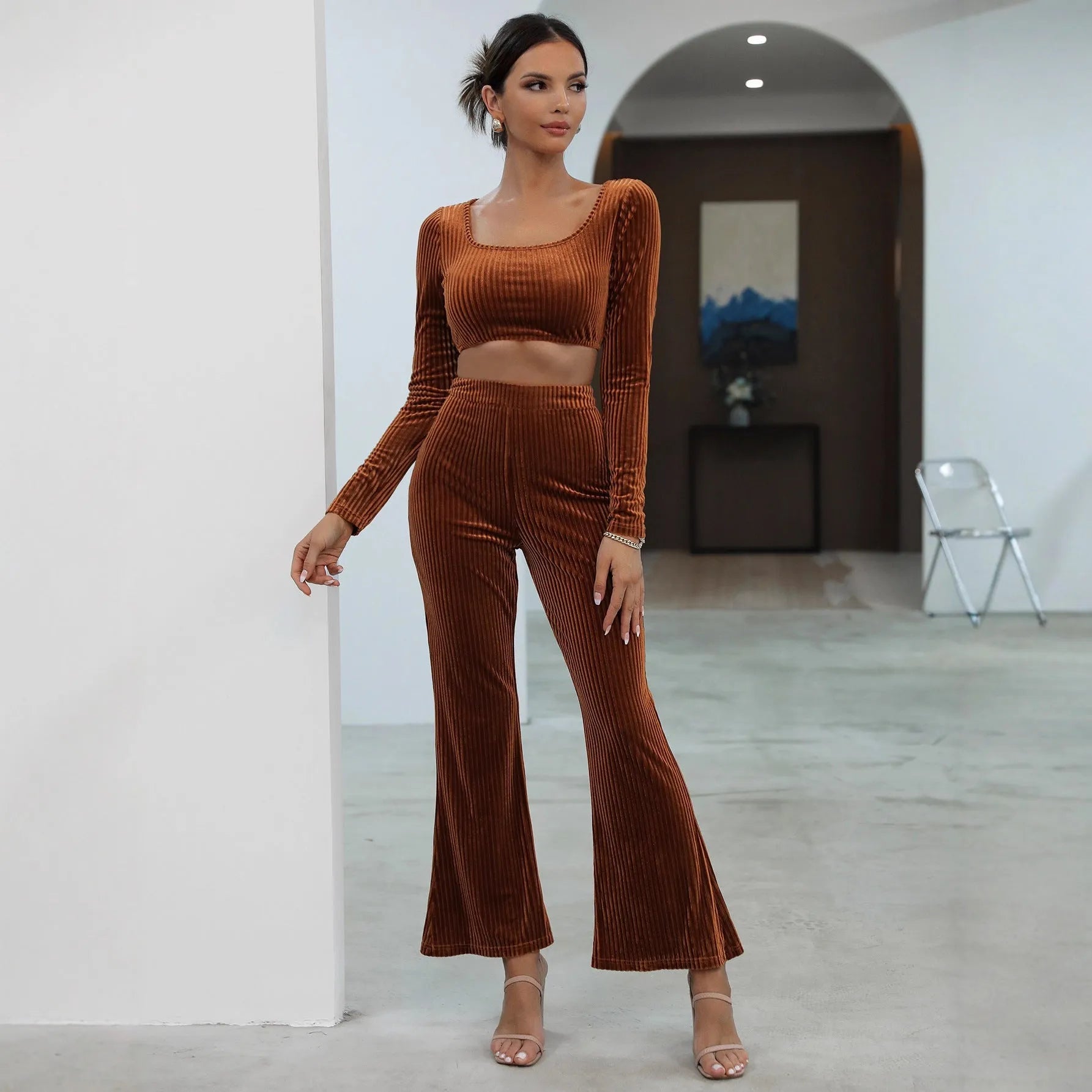 Caramel coloured women's long sleeve sweater and matching straight-leg trousers set on a hanger.