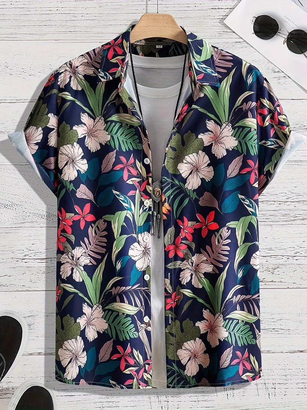 Man wearing a loose-fitting short sleeve shirt with a bold 3D floral print pattern.