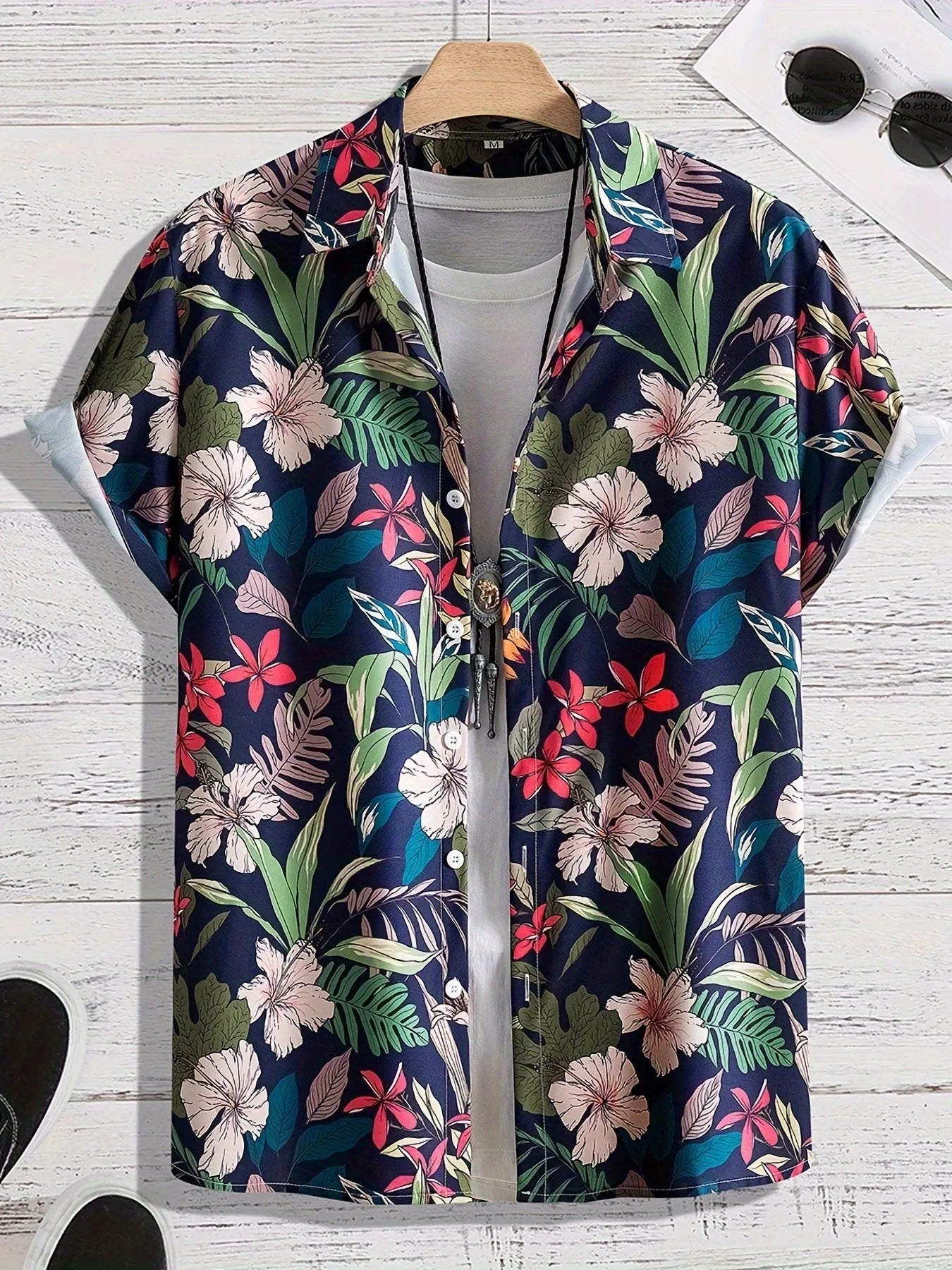 Man wearing a loose-fitting short sleeve shirt with a bold 3D floral print pattern.