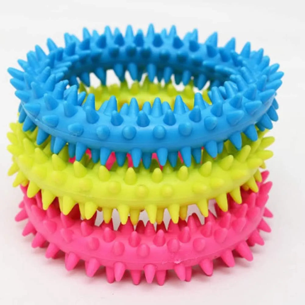 Blue TPR spiky circle ring dog chew toy for teeth cleaning on a white background.