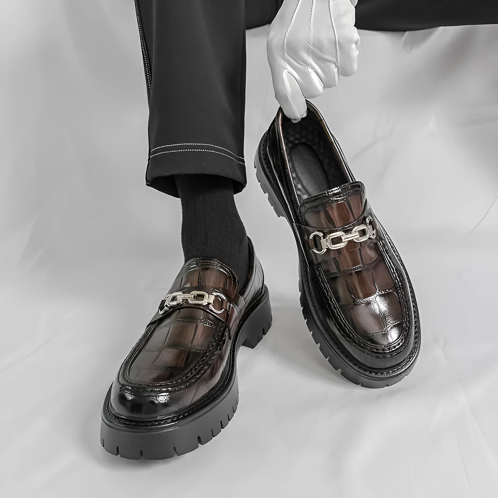 Men's crocodile print platform loafers in black, brown and yellow colours showing textured leather and flat heel design