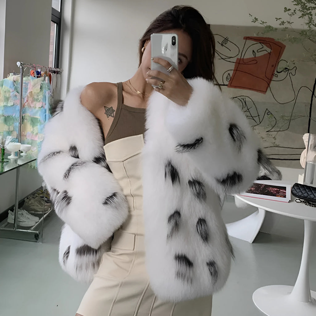 Black and white artificial fur women's coat with a slim fit, short length, and regular sleeves.