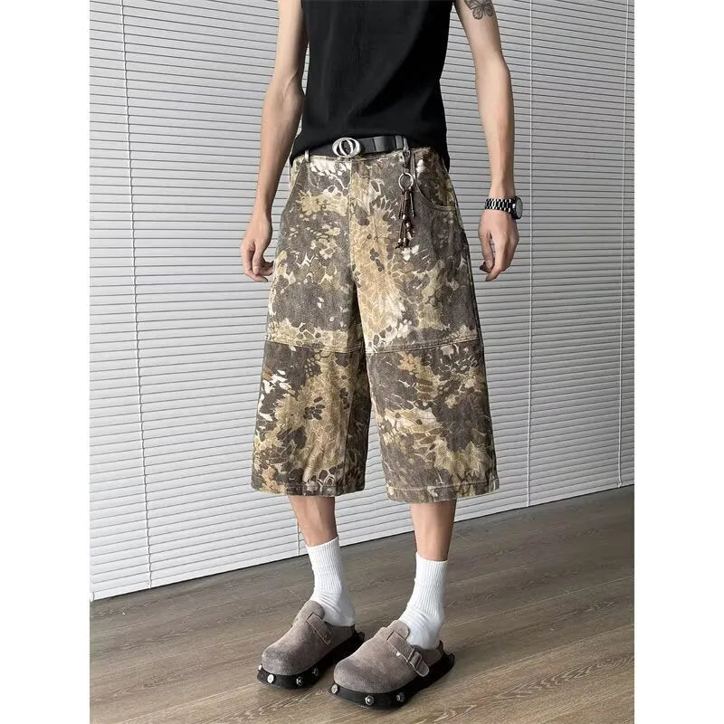 Yellow denim jeans with a snake camouflage pattern and cropped leg hem.