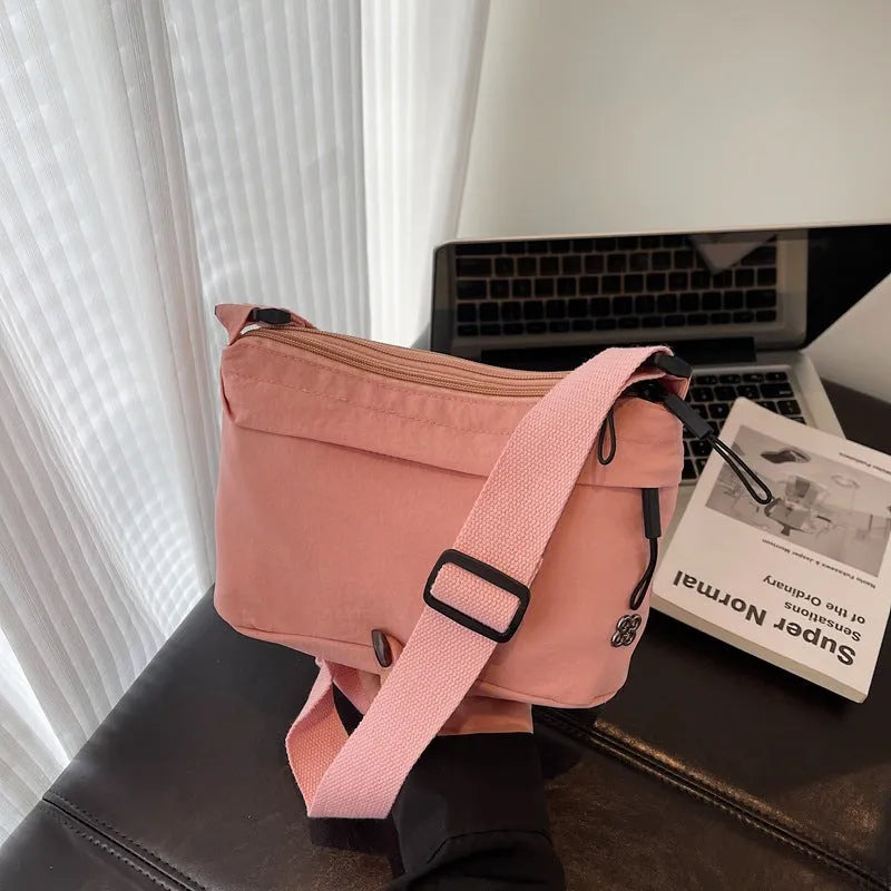 Soft cloth daily lightweight commuter crossbody bag in beige with sandwich pocket and sewn-thread detailing