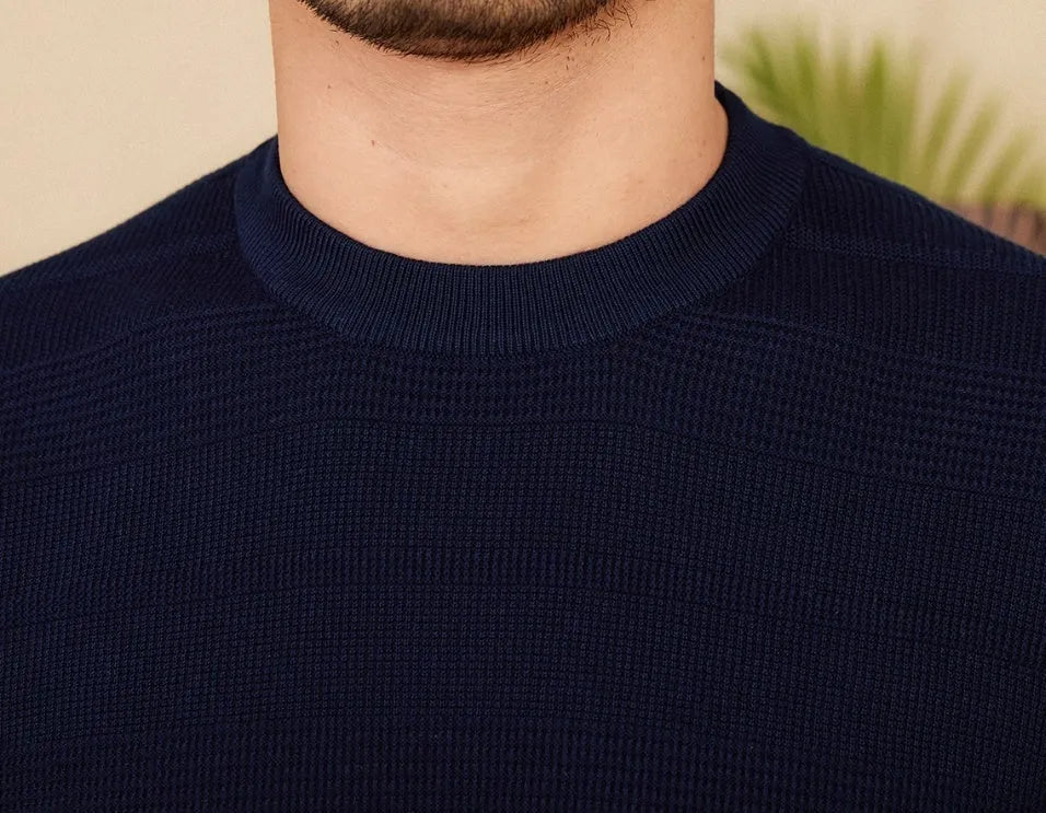 Men's off-white pure cotton short sleeve t-shirt with a round neck, laid flat on a surface.