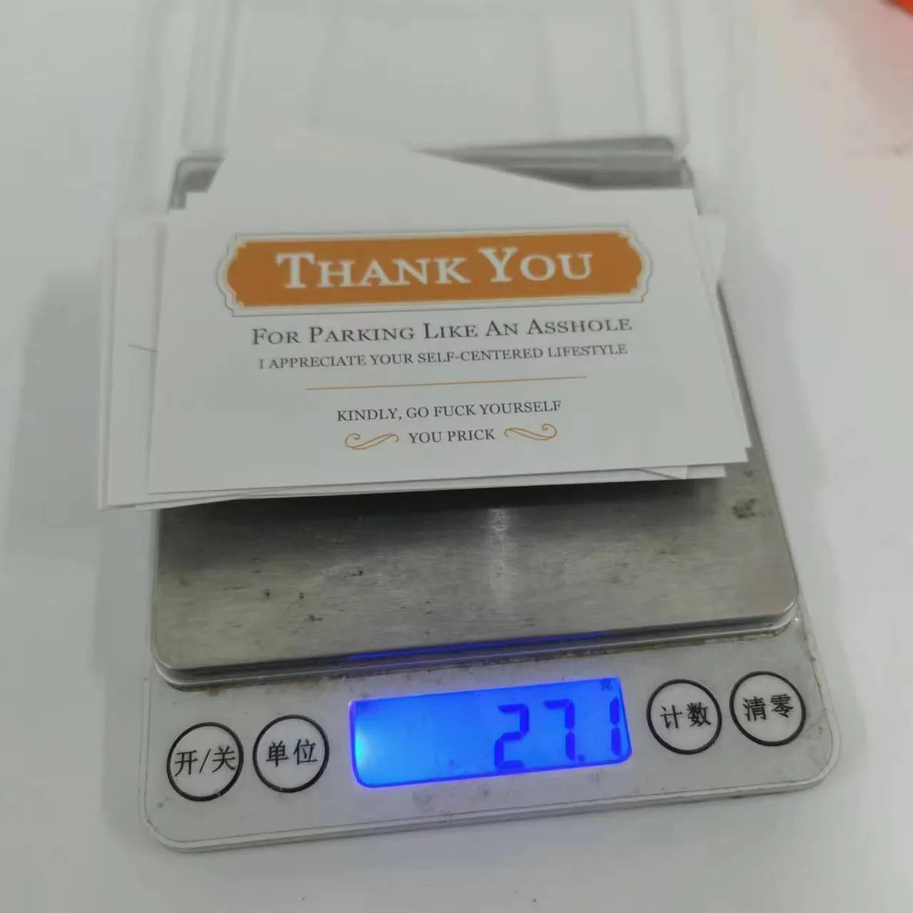 Box of paper illegal parking reminder cards showing a middle finger graphic.