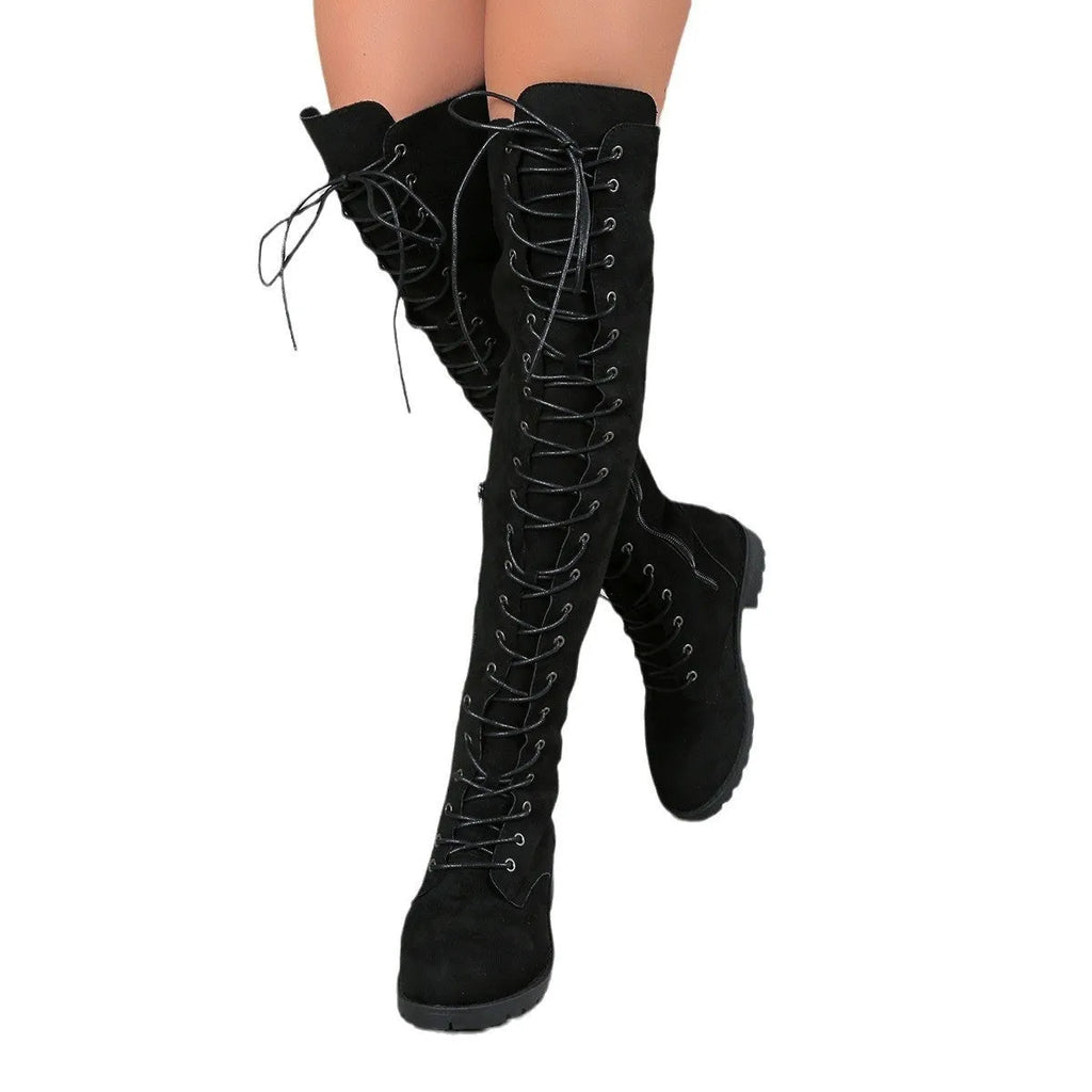Black lace-up over-the-knee boots with decorative stitching, a round toe, and a flat rubber sole on a neutral background.