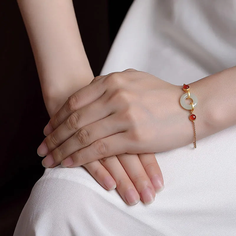 Women's S925 sterling silver gold-plated bracelet with inlaid natural Hetian jade and a peace buckle clasp.