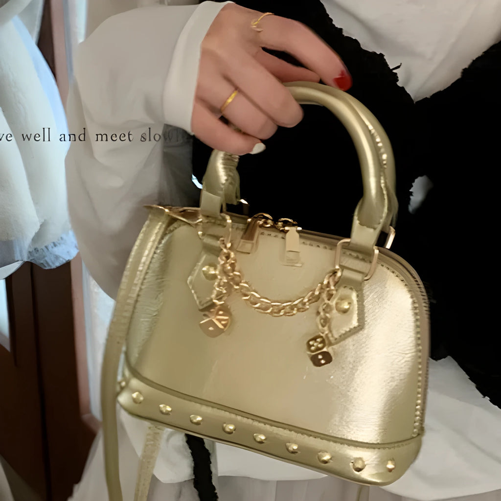 Champagne-gold PU shell bag with stitched seams, shown in shoulder mode against a neutral background
