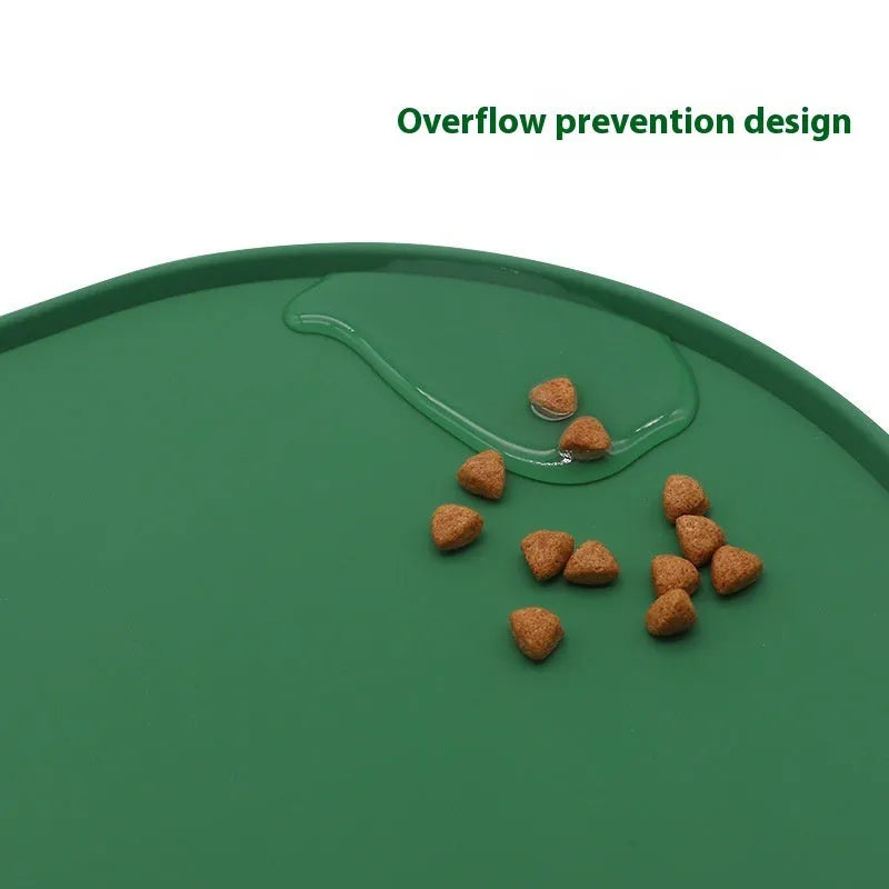 Beige silicone cat feeding mat with raised edges holding a food and water bowl on a wooden floor.