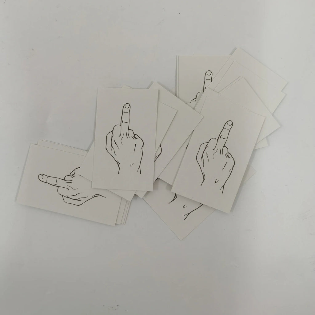 Box of paper illegal parking reminder cards showing a middle finger graphic.