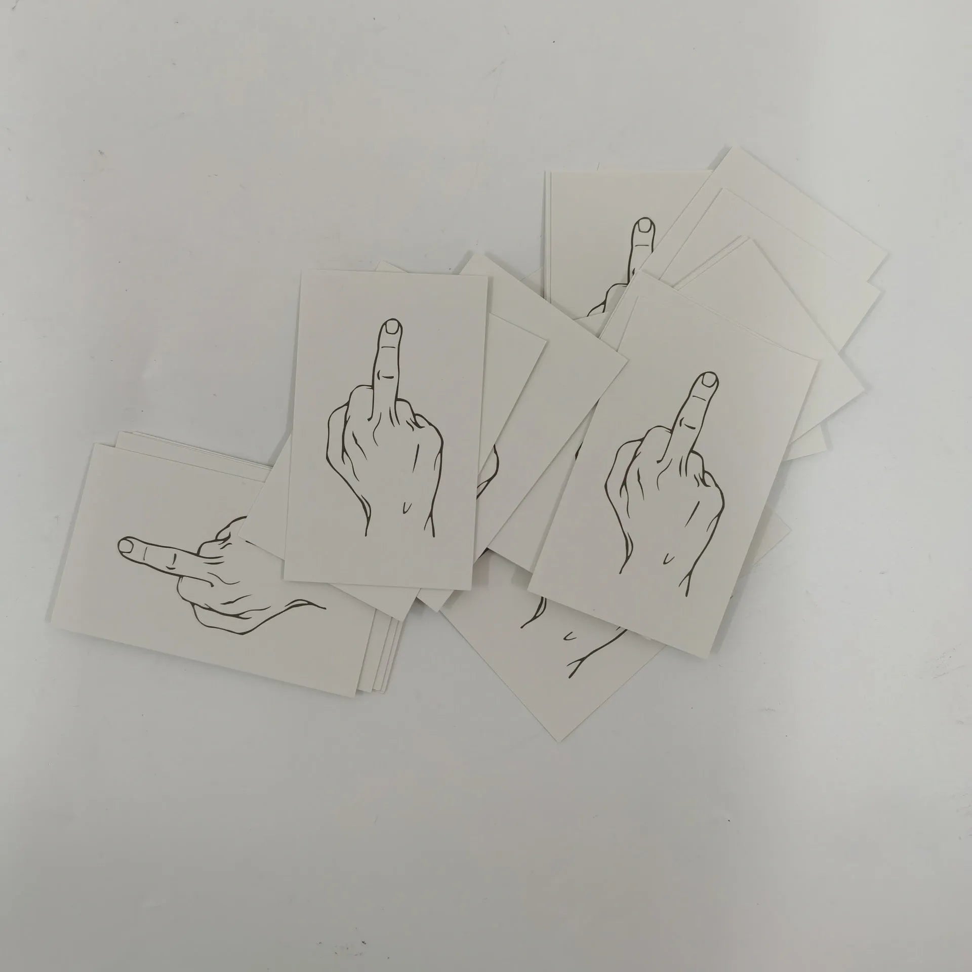 Box of paper illegal parking reminder cards showing a middle finger graphic.