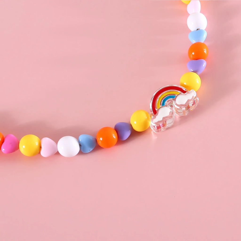Colourful plastic bead pet necklace for cats in peach, rainbow, or small flower patterns on a white background.