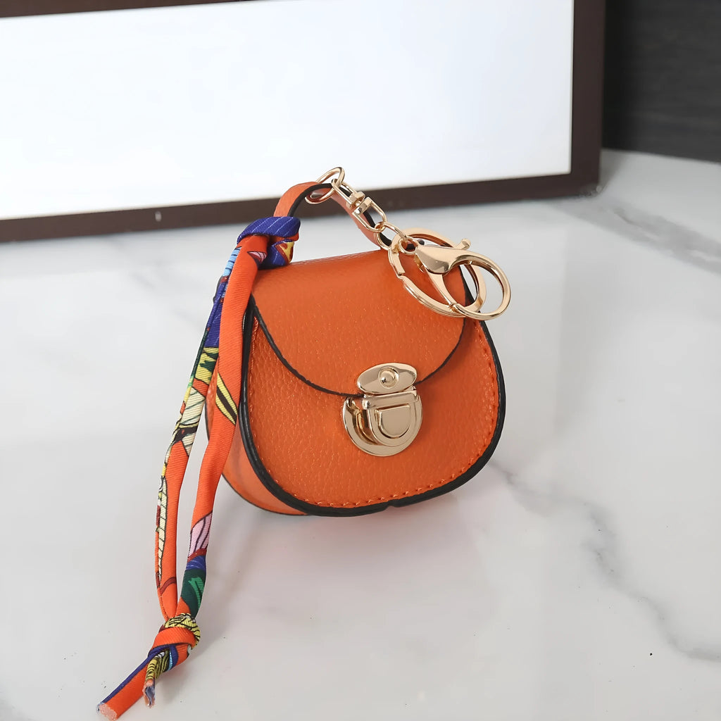 Small PVC coin purse keychain pendant in a solid colour, shown attached to a keyring.