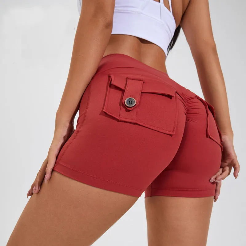 Women's high waist hip lifting fitness shorts in a solid colour with side pockets, on a mannequin.