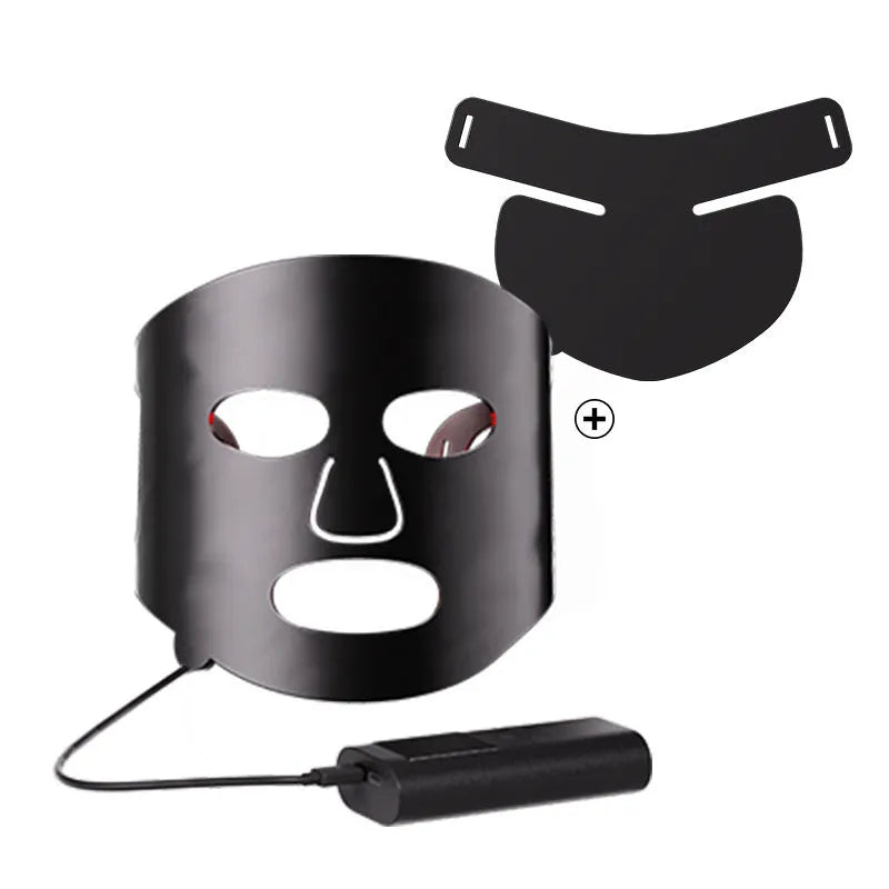 Black and white LED phototherapy face mask with controller on a strap for home skincare use.