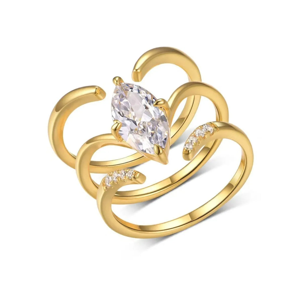 Gold zinc alloy three-piece geometric ring set with horse eye inlay on white background