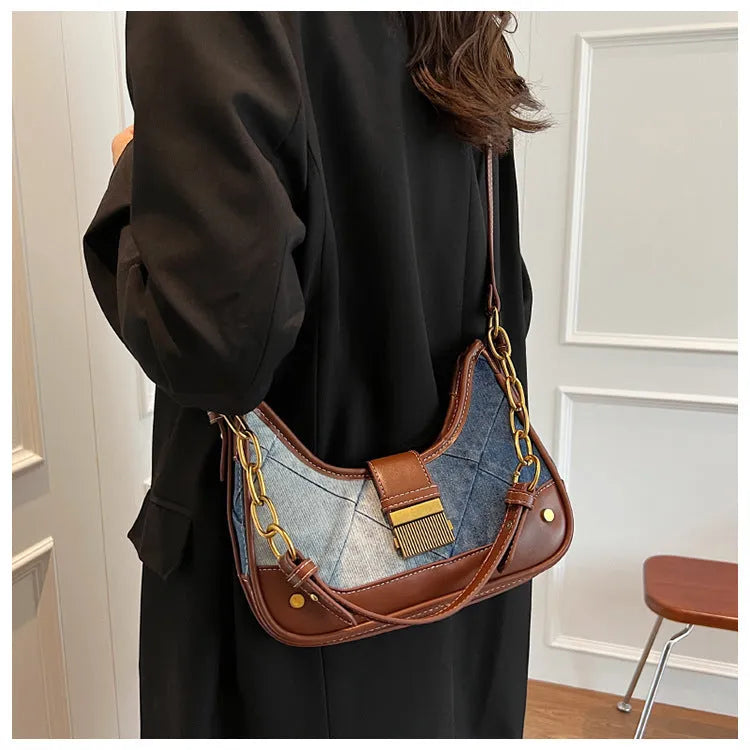 Brown denim women's bucket shoulder bag with diamond mesh detail and a chain strap.